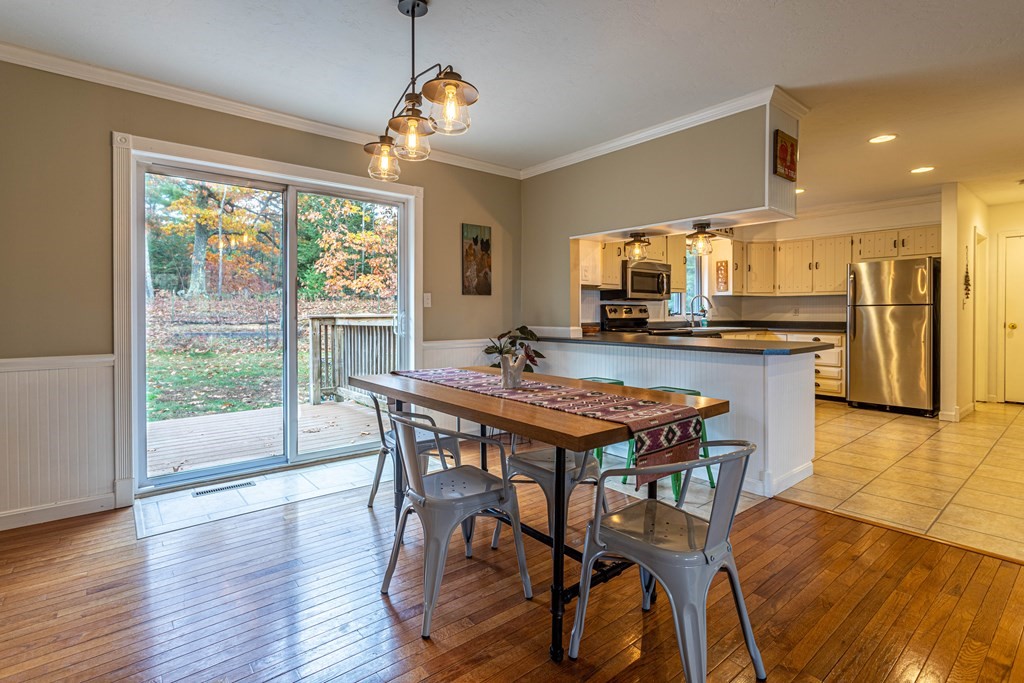 227 Ellis Road Westminster, MA 01473 - Photo 8 of 31 a dining room with stainless steel appliances granite countertop a table chairs a sink and dishwasher a refrigerator with wooden floor