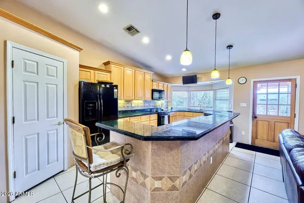 a view of a kitchen with furniture and chandelier
