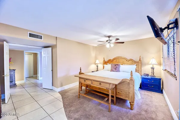 a bedroom with a bed and a chandelier