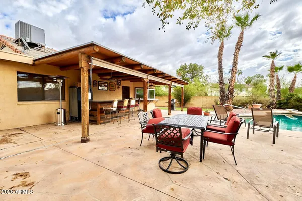 a patio with a table and chairs