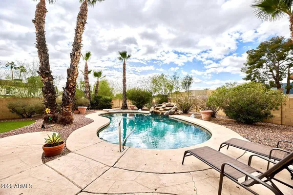 a swimming pool with outdoor seating and yard