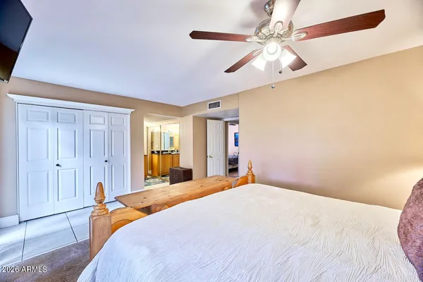 a bedroom with a bed and a chandelier