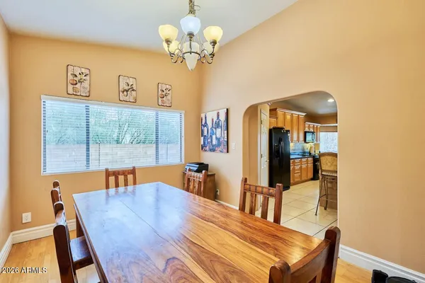 a view of a dining room with furniture a chandelier and wooden floor