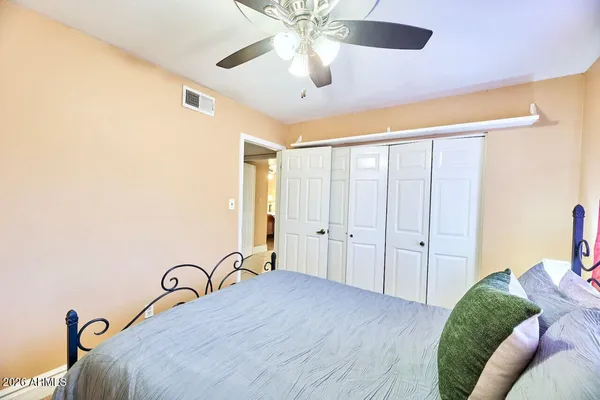 a bed room with a bed and a chandelier