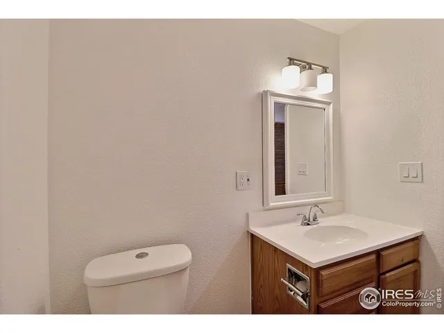 a bathroom with a sink toilet and mirror