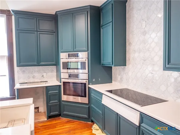 a kitchen with wooden cabinets and a sink
