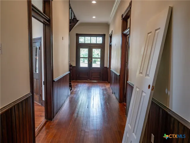 an empty room with wooden floor and closet