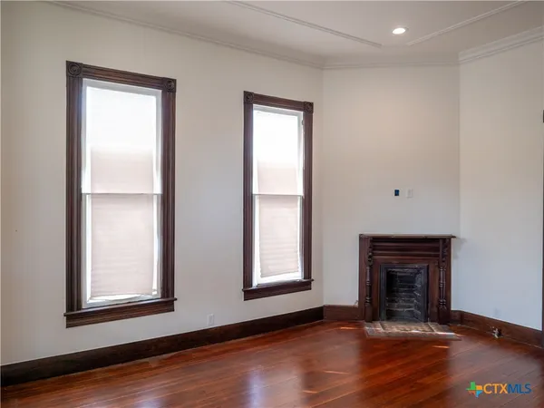an empty room with wooden floor and closet