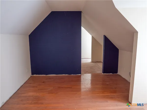 a bathroom with a toilet and a mirror