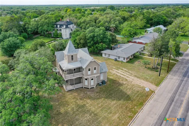 an aerial view of a house with a big yard