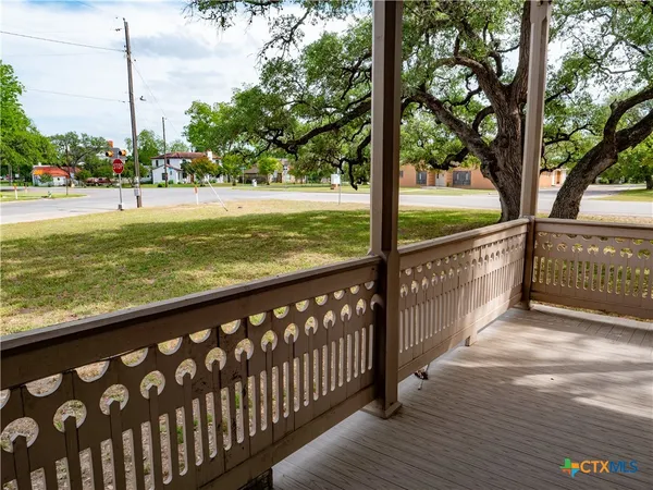 a view of a balcony with lake view and wooden floor