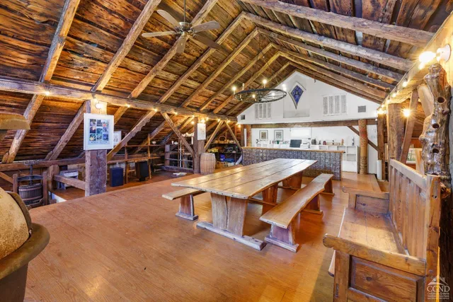 a roof deck with table and chairs