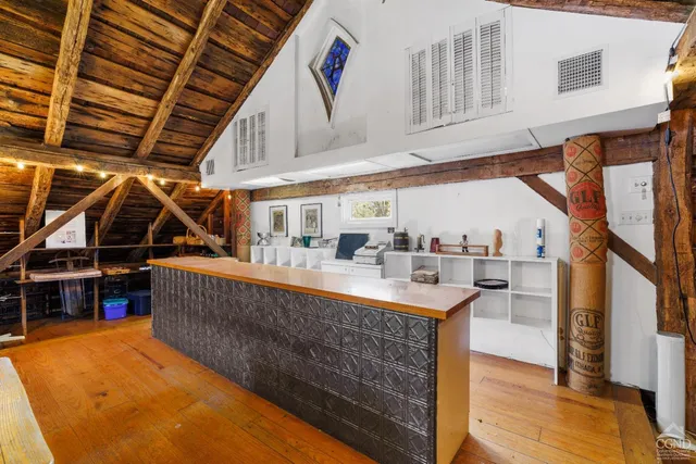 a bathroom with a walk in closet and wooden floor