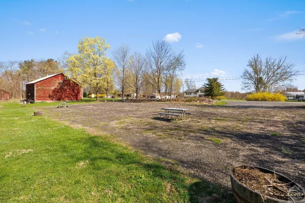a city street with tall buildings and cars parked on road