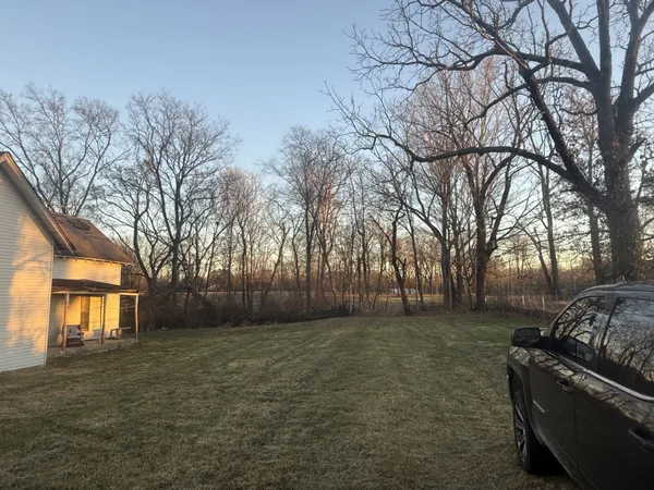 a backyard of a house with large trees