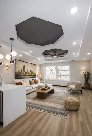 a living room with furniture kitchen view and a large window