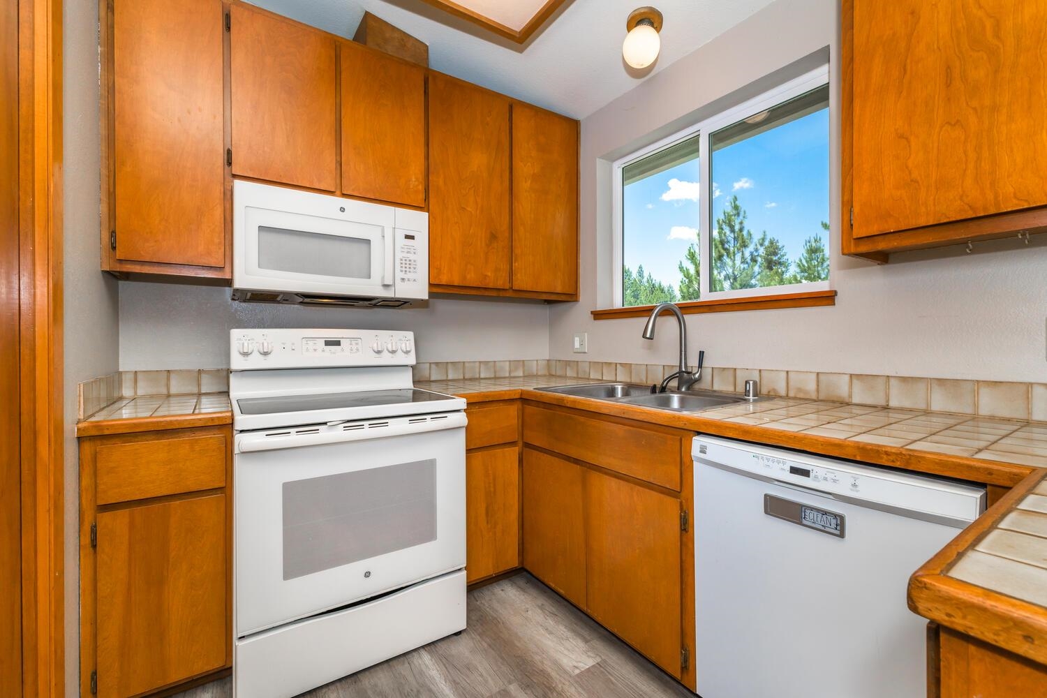 10332 Sugar Pine Road Truckee, CA 96161 - Photo 12 of 25 a kitchen with stainless steel appliances granite countertop a sink stove and microwave