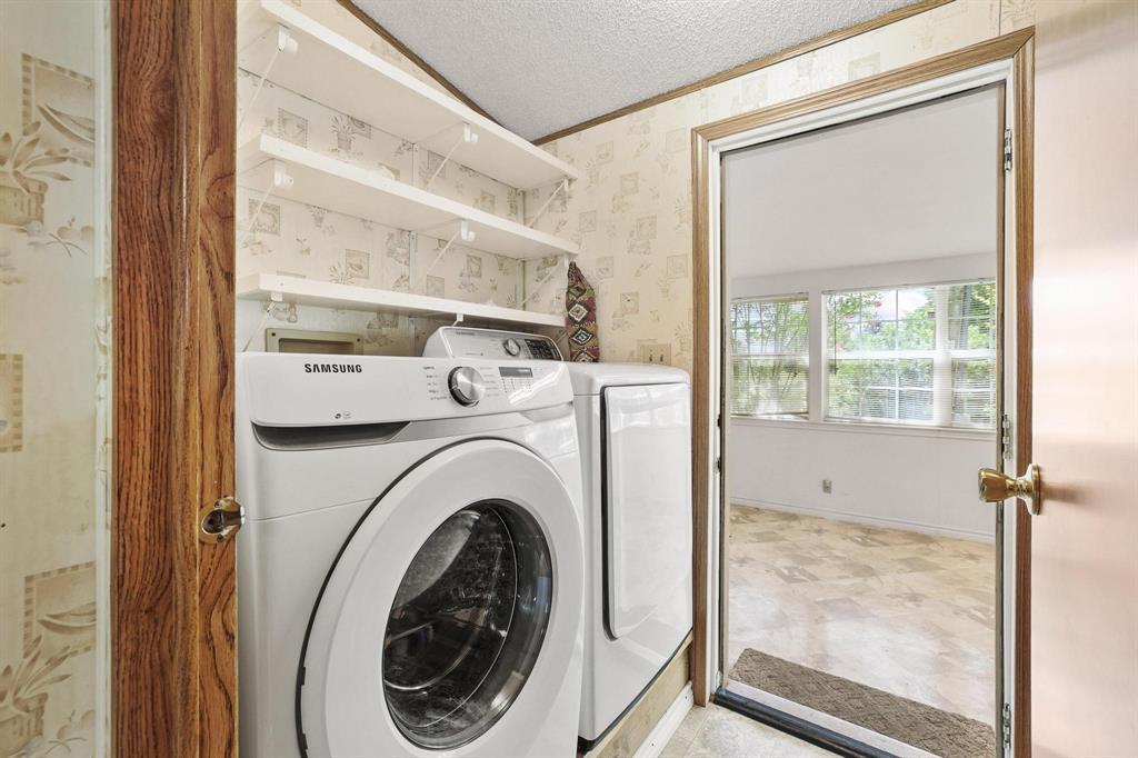 2496 Greer Road Sadler, TX 76264 - Photo 21 of 39 Dedicated laundry area featuring white front-load appliances and wall-mounted shelving