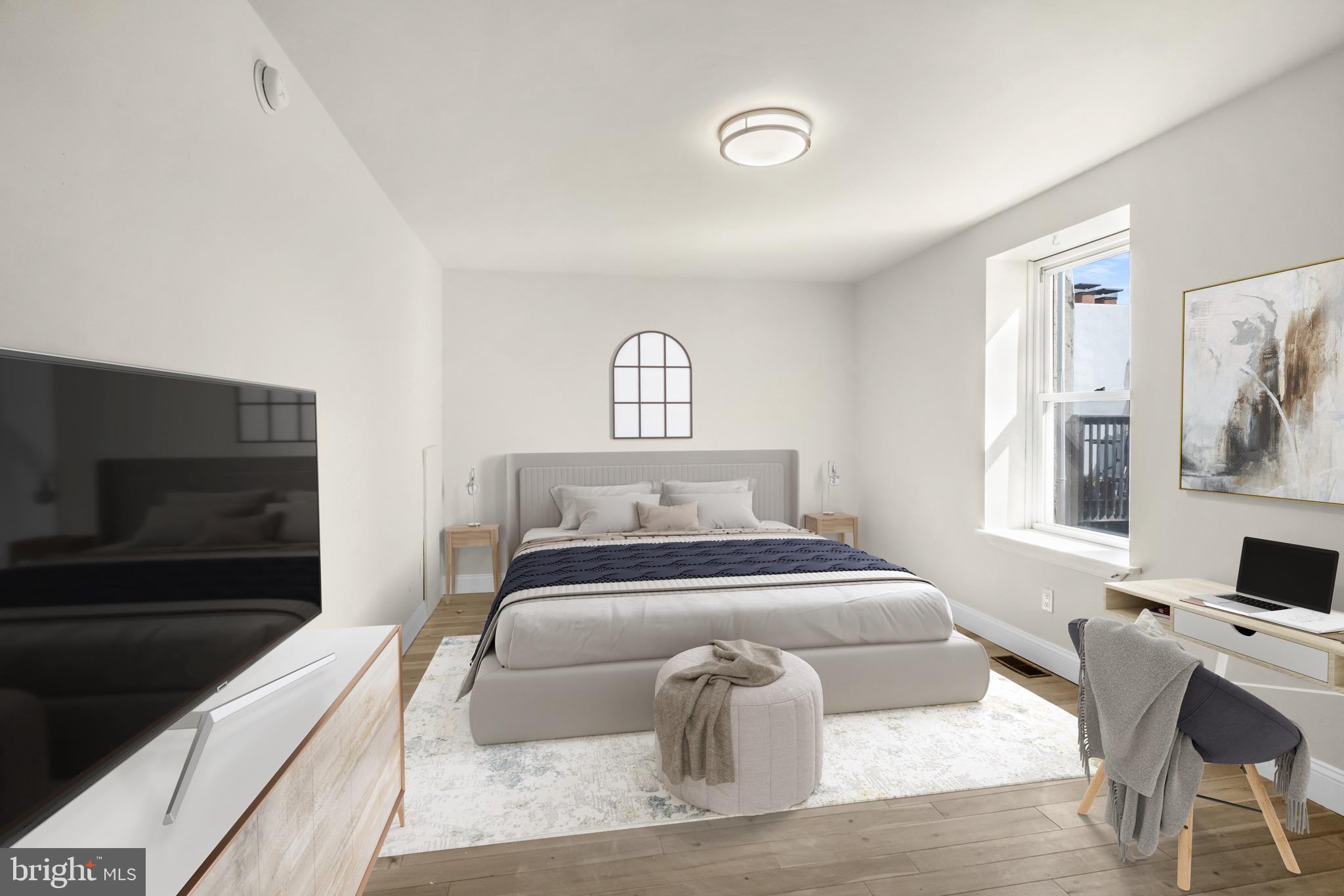 234 Bainbridge Street, Unit 2F Philadelphia, PA 19147 - Photo 7 of 10 a bedroom with a bed and a couch