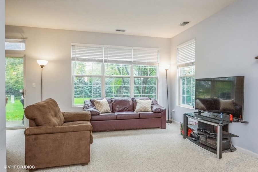 24099 Pear Tree Circle Plainfield, IL 60585 - Photo 2 of 17 a living room with furniture and a flat screen tv