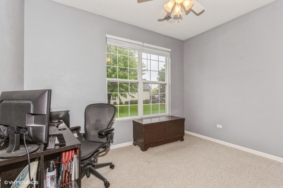 24099 Pear Tree Circle Plainfield, IL 60585 - Photo 6 of 17 a livingroom with workspace and a window