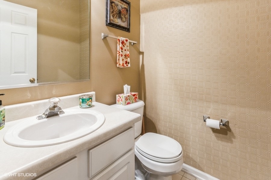 24099 Pear Tree Circle Plainfield, IL 60585 - Photo 9 of 17 a bathroom with a sink toilet and a mirror