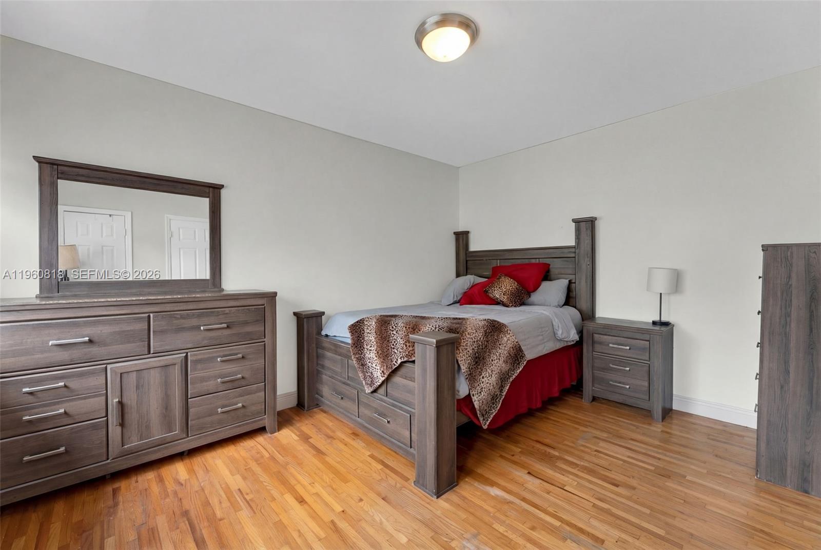 320 85th Street, Unit 15 Miami Beach, FL 33141 - Photo 4 of 13 a bedroom with a bed and a dresser