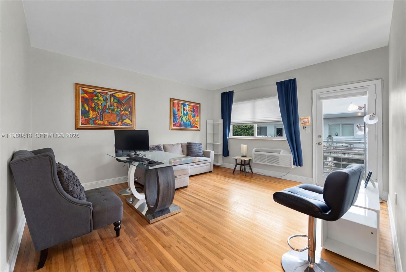 320 85th Street, Unit 15 Miami Beach, FL 33141 - Photo 7 of 13 a workspace with furniture hardwood and a window