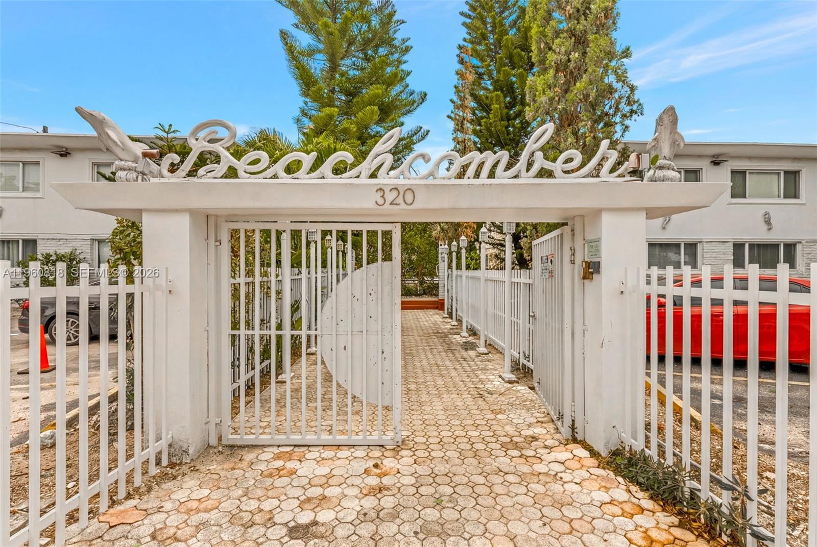 320 85th Street, Unit 15 Miami Beach, FL 33141 - Photo 10 of 13 a view of a brick house with large windows and a table