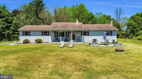 a view of a house with a backyard patio and swimming pool