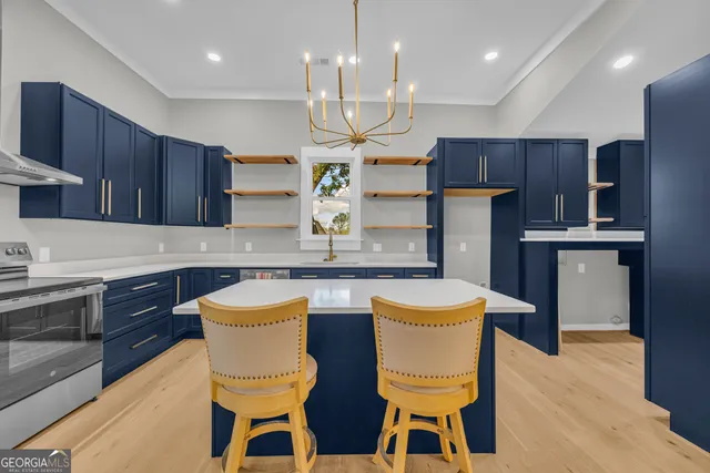 a bedroom with a bed chandelier and a window
