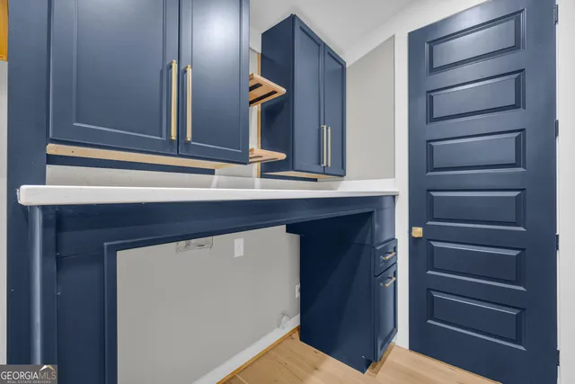 a storage & utility room with wooden floor
