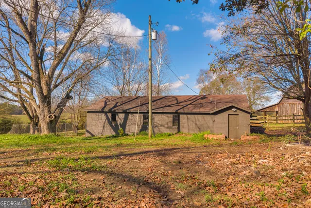 a living room with couches chandelier and a window
