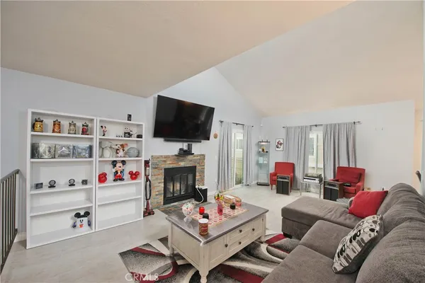 a bedroom with a bed couch and a window
