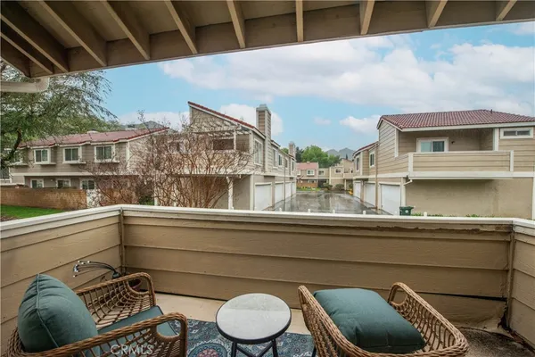a view of roof deck with chair and wooden floor