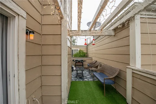 a backyard of a house with table and chairs