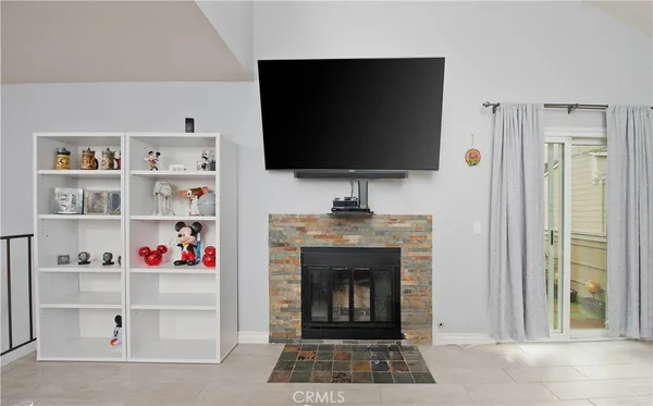 a living room with a flat screen tv and a fireplace