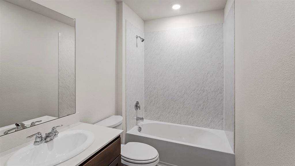 1675 Mantle Road Crandall, TX 75114 - Photo 26 of 27 Bathroom featuring a white vanity with a rectangular sink, chrome faucet, and integrated mirror