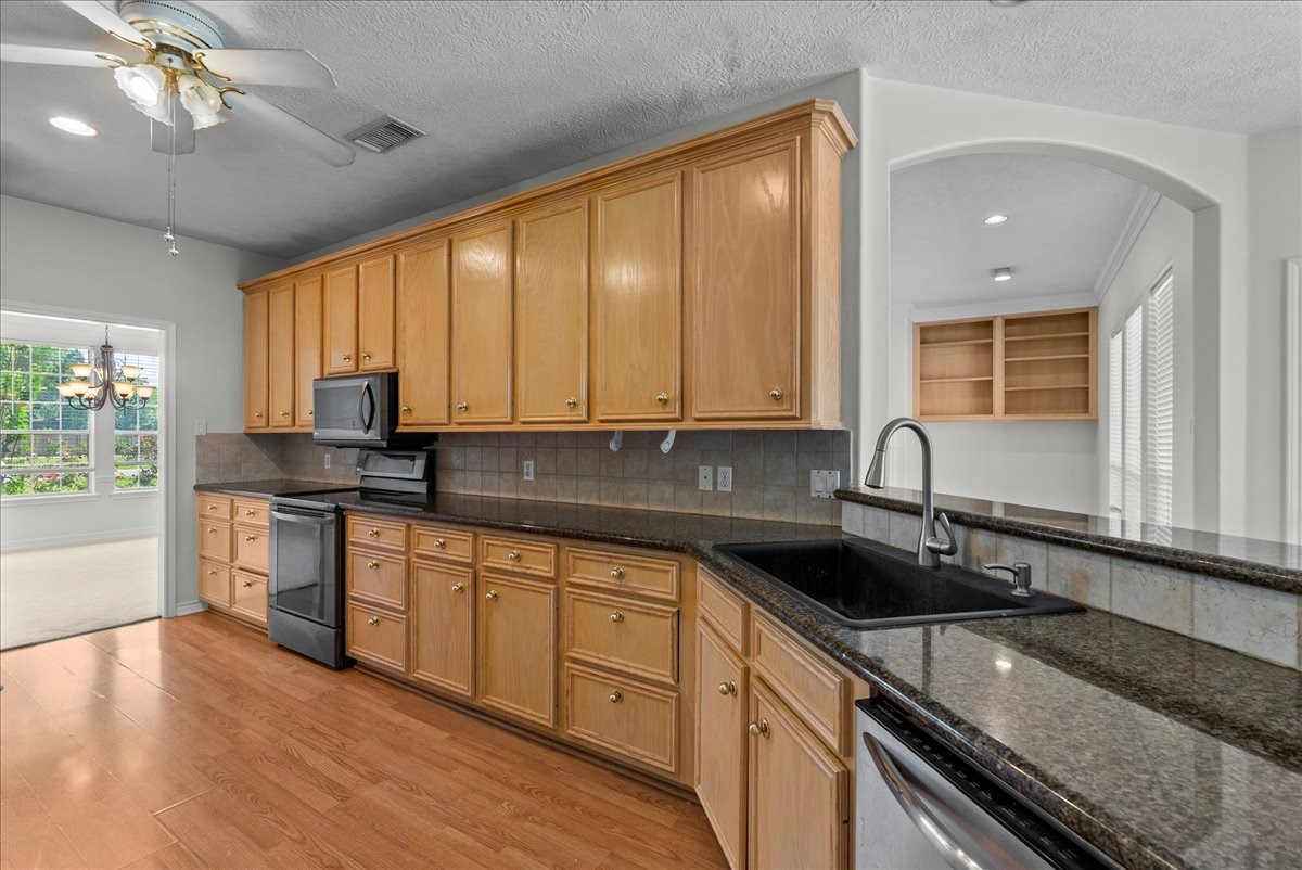 1607 Delta Lane Baytown, TX 77523 - Photo 15 of 48 The kitchen has plenty of cabinets and sleek black granite.