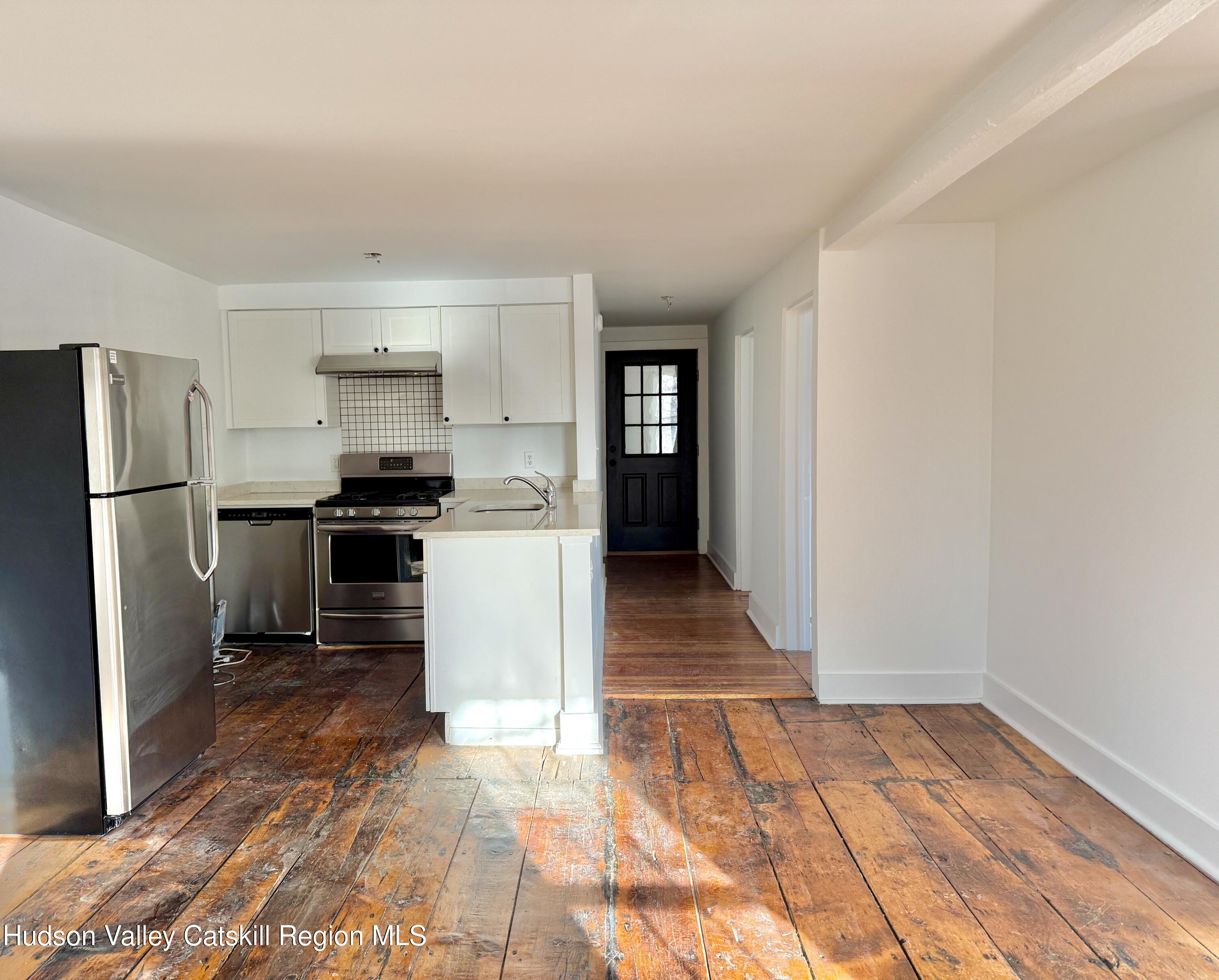 a kitchen with granite countertop a refrigerator and a stove