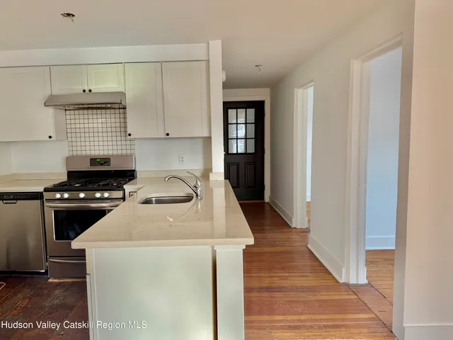 a kitchen with a stove and a refrigerator