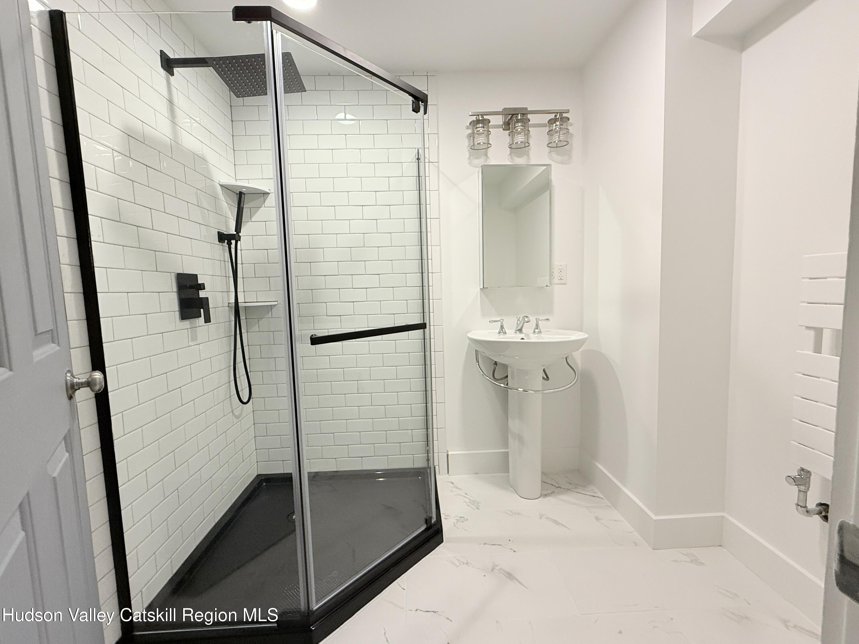 624 Warren Street, Unit 2 Hudson, NY 12534 - Photo 5 of 8 a bathroom with a shower and mirror
