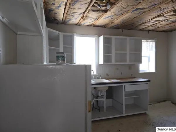 a kitchen with a sink a window and stainless steel appliances