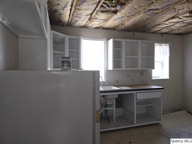 243 Main Street Carthage, IL 62321 - Photo 11 of 26 a kitchen with a sink a window and stainless steel appliances