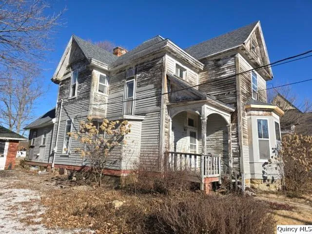 a view of a brick house with a yard