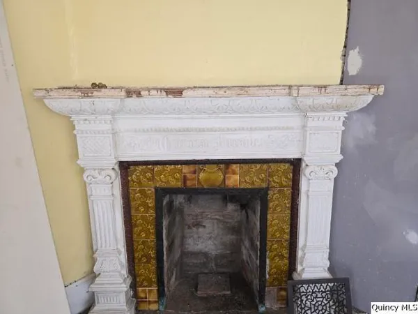 a close view of a fireplace with wooden floor