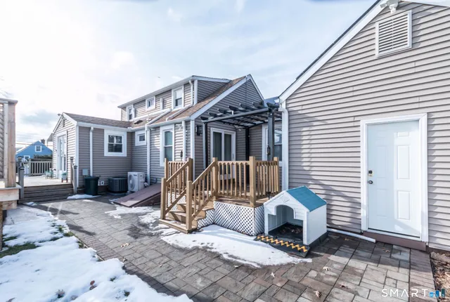 a view of a house with a wooden deck