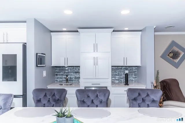 a kitchen with stainless steel appliances a refrigerator and a stove top oven