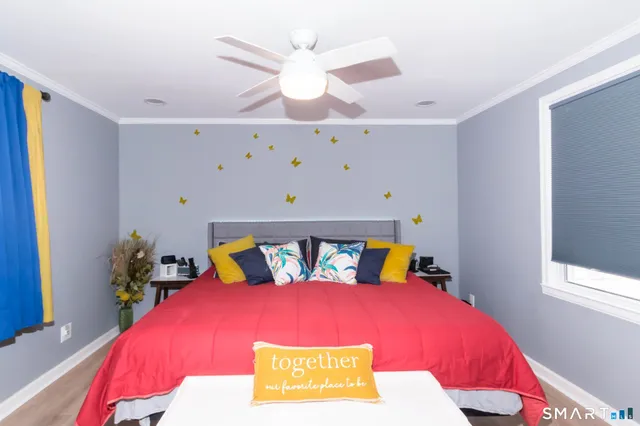 a bedroom with a bed and a flat screen tv