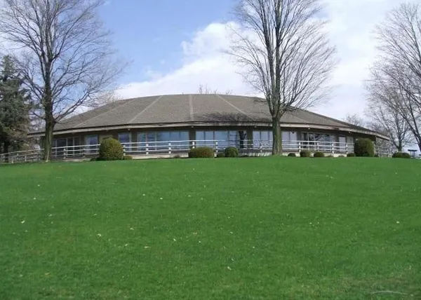 a front view of house with a garden